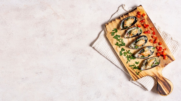 Tasty mussel shells on a wooden board