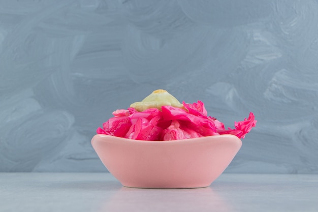 Tasty pickled cabbage in pink bowl.  