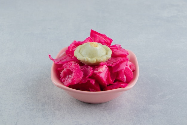 Tasty pickled cabbage in pink bowl. 