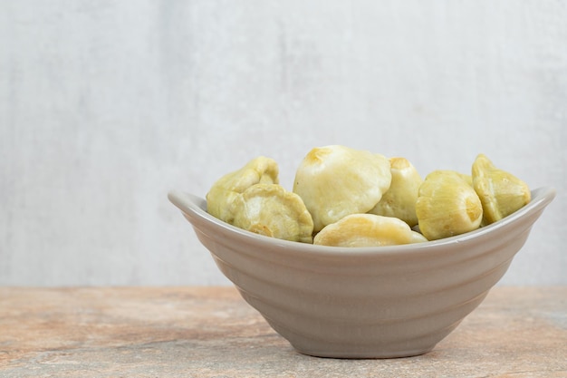 Tasty pickled fruits in gray bowl