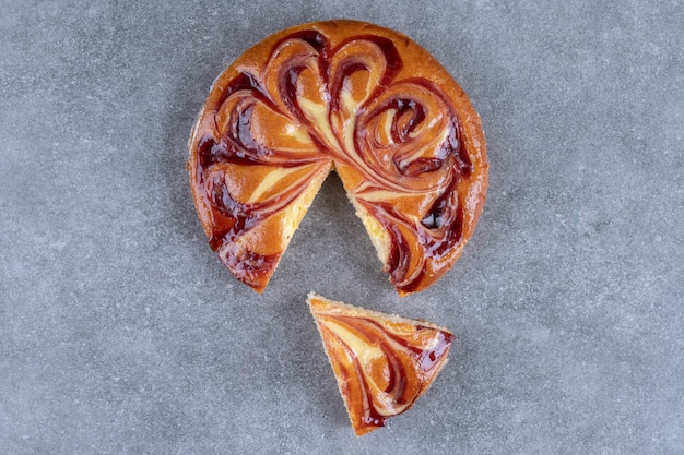 Tasty pie with berry juice on marble surface