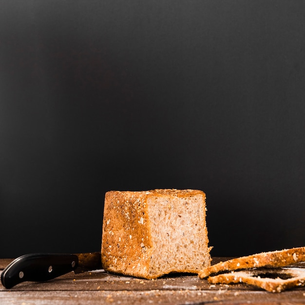 Free photo tasty piece of bread next to a knife