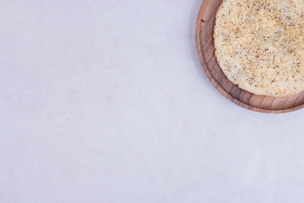 Tasty pizza on wooden plate on white