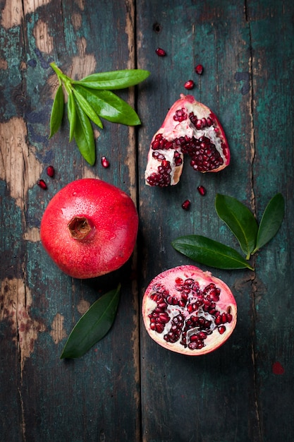 Tasty pomegranate with green leaves