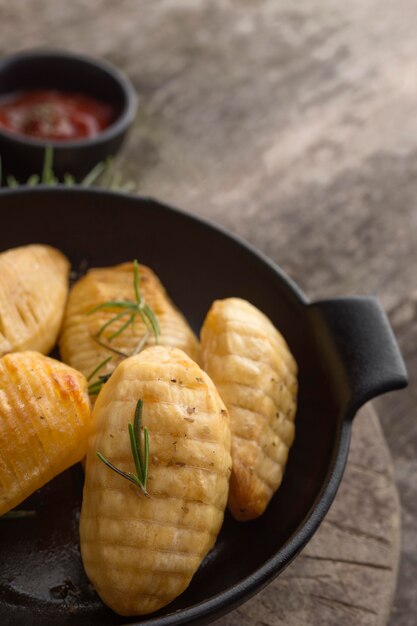 Tasty potatoes in bowl with herbs