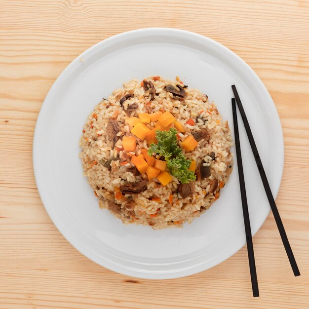 Tasty rice dish and chopsticks