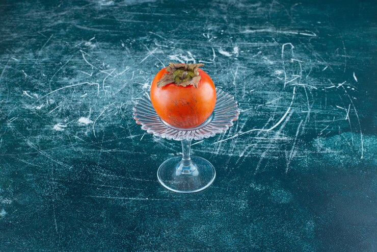 Free Photo tasty ripe persimmon on glass plate. 
