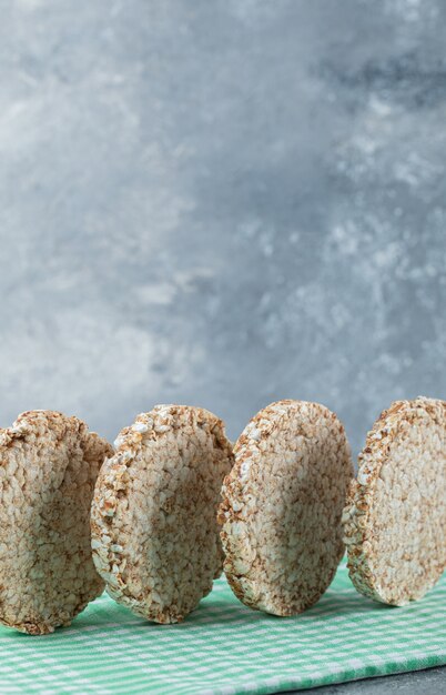 Tasty round rice cakes on striped tablecloth.