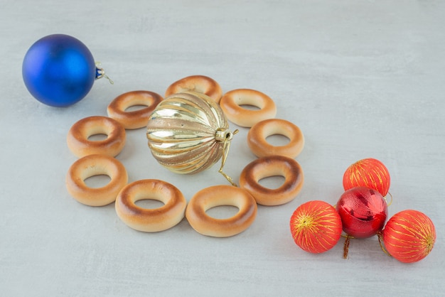 Tasty round sweet cookies with colorful Christmas balls on white backround. High quality photo