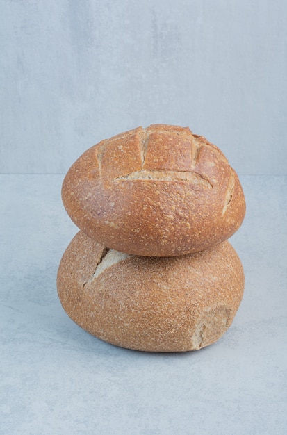 Tasty rye buns on marble background. High quality photo