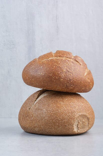 Tasty rye buns on stone surface