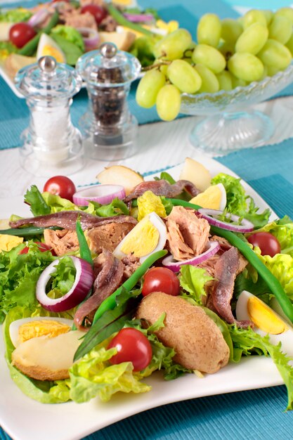 Tasty salad arranged on table