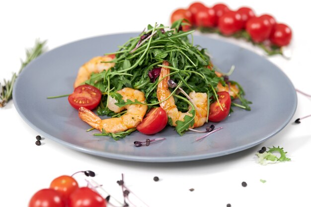 Tasty salad with juicy shrimpstomatoes and fresh arugula