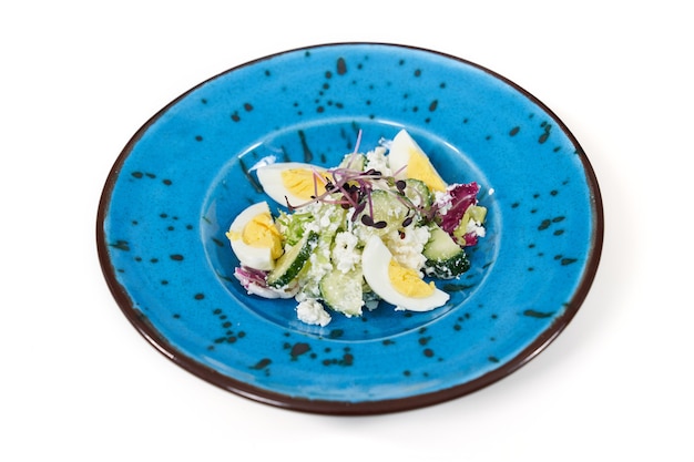 Tasty salad with vegetables and eggs in beautiful plate