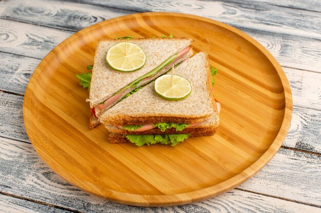 tasty sandwiches with green salad ham and tomatoes