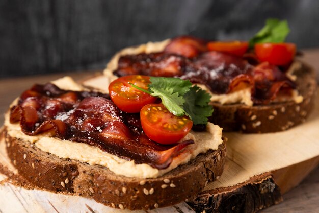 Tasty sandwiches with tomatoes and bacon