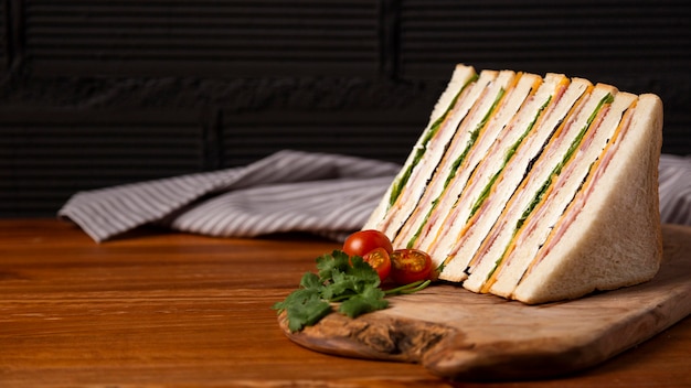 Tasty sandwiches on wooden board