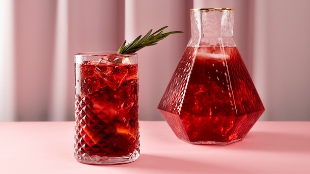 Tasty sangria with herbs and pink background