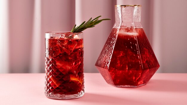 Tasty sangria with herbs and pink background