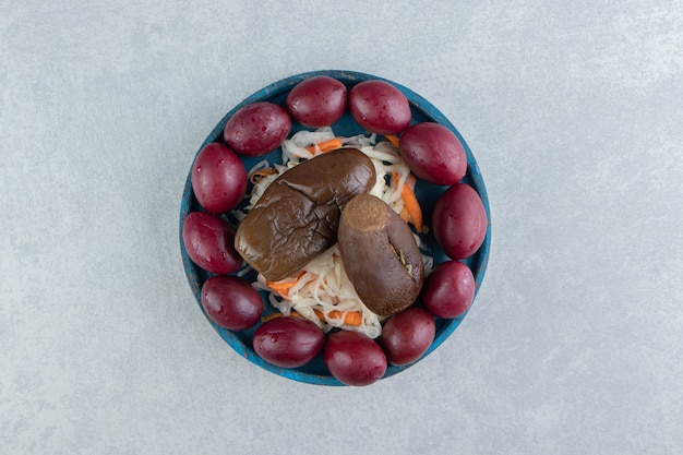 tasty-sauerkraut-eggplant-plums-blue-plate_114579-82197.jpg