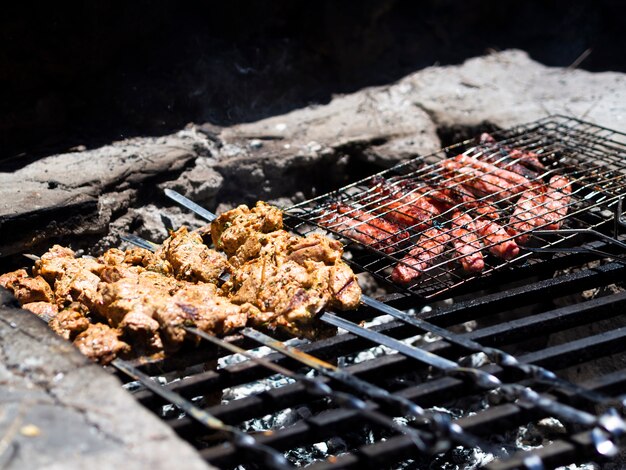 Tasty shish kebab and steaks on grill