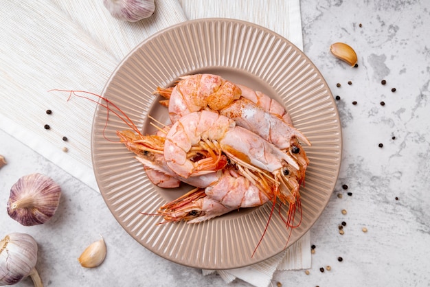 Tasty shrimps on plate flat lay