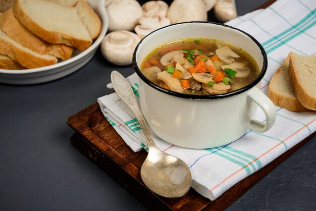 Tasty soup in pan over gray surface. Close up.