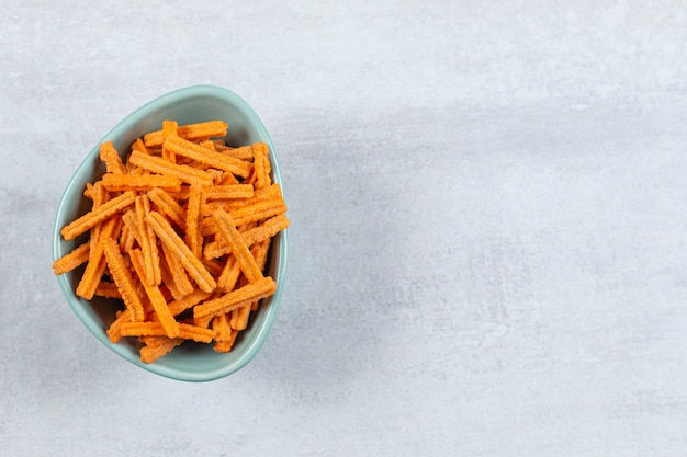 Tasty stick chips in blue bowl