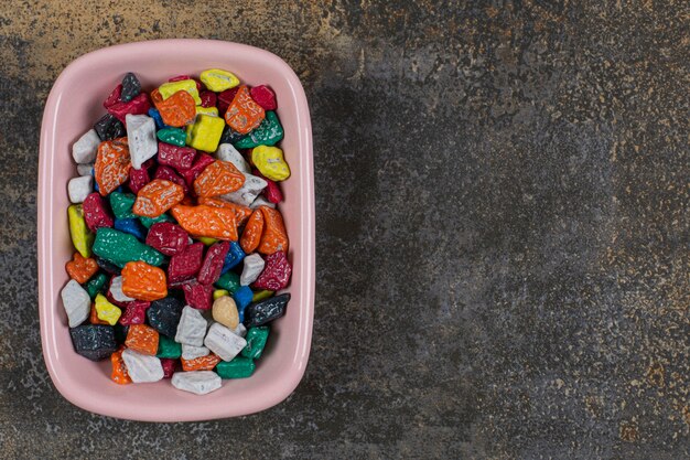 Tasty stone candies in pink bowl.