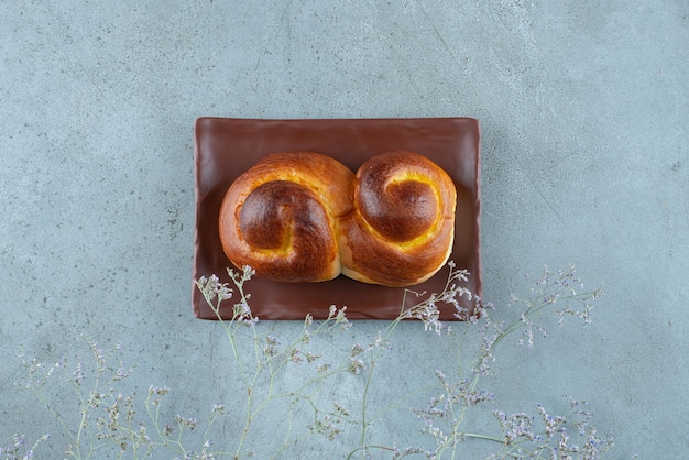 Tasty sweet pastry on brown plate.