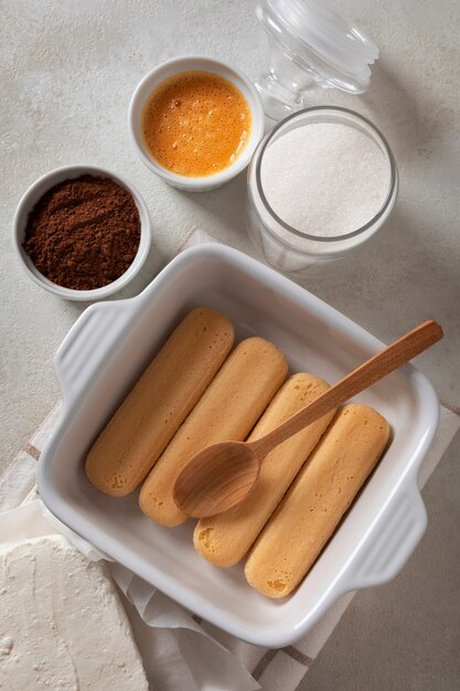 Tasty tiramisu ingredients assortment flat lay