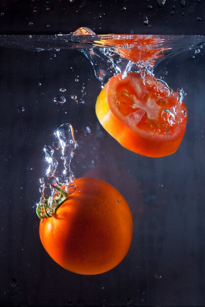 Tasty tomatoes immersed in water