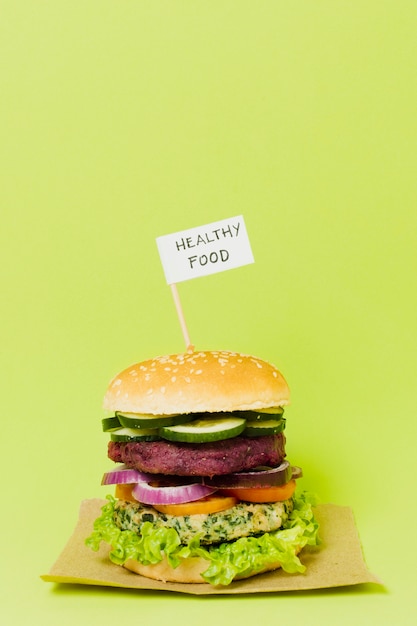 Free photo tasty vegan burger with healthy food sign