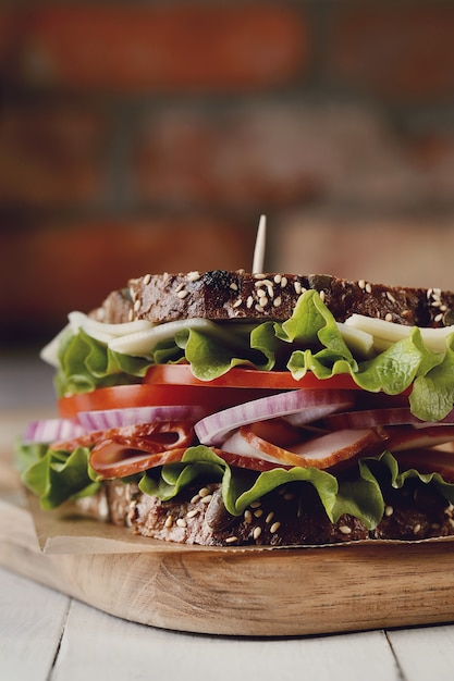 Tasty vegan sandwich over wooden table