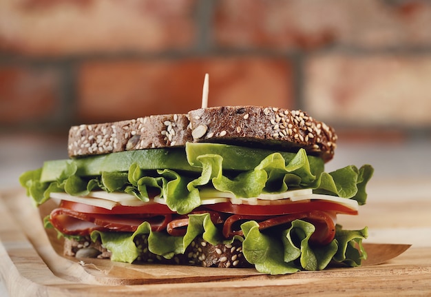 Tasty vegan sandwich over wooden table