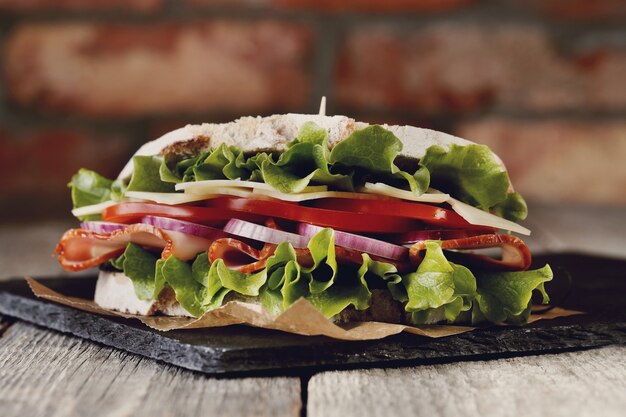 Tasty vegan sandwich over wooden table