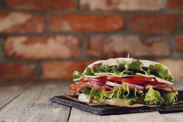 Tasty vegan sandwich over wooden table