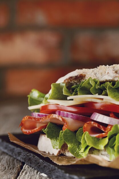 Tasty vegan sandwich over wooden table