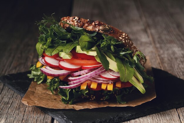 Tasty vegan sandwich over wooden table