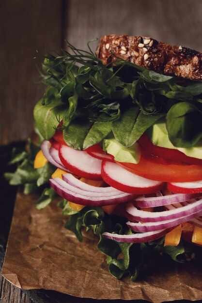 Tasty vegan sandwich over wooden table