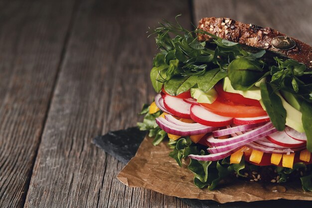 Tasty vegan sandwich over wooden table