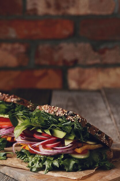 Tasty vegan sandwich over wooden table