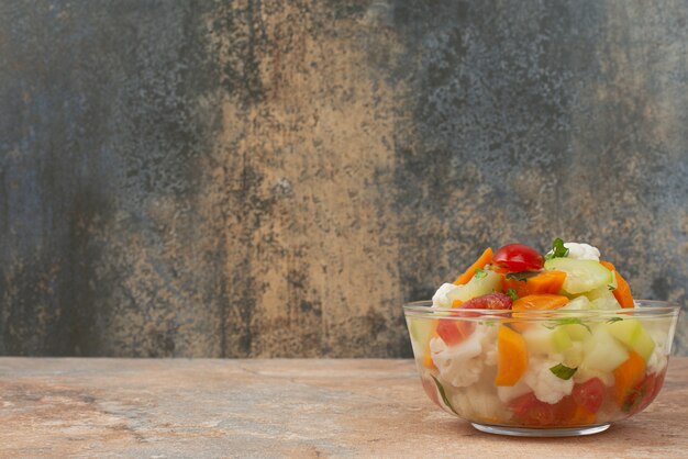 Free photo tasty vegetables on glass plate on marble.