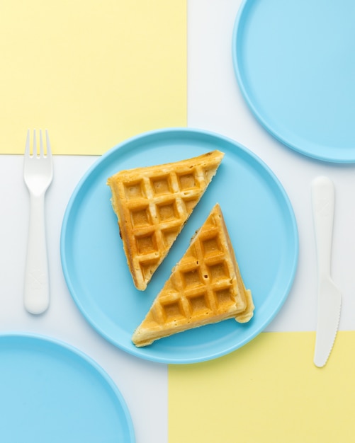 Free photo tasty waffle on childish blue plate, top view