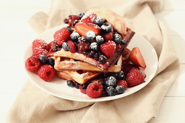 Tasty waffle with blueberries and strawberries