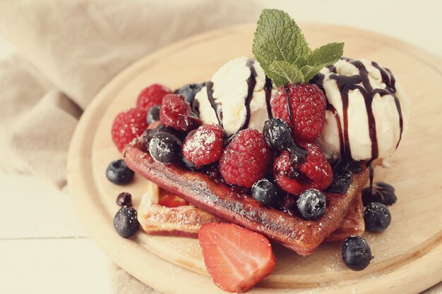 Tasty waffle with blueberries and strawberries