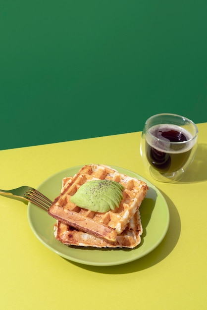 Free photo tasty waffles with avocado high angle