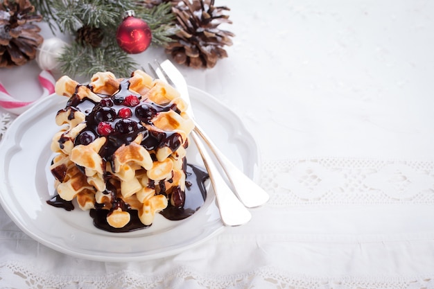 Tasty waffles with christmas background