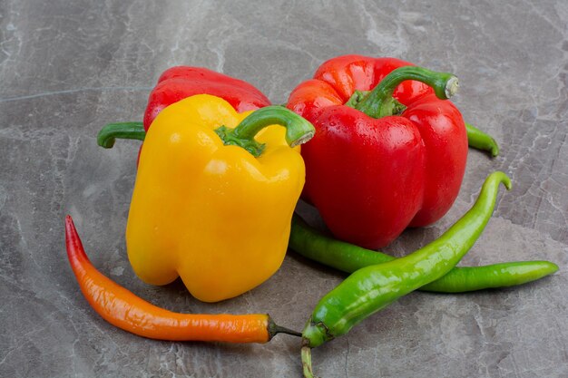 Tasty whole peppers on marble background. High quality photo