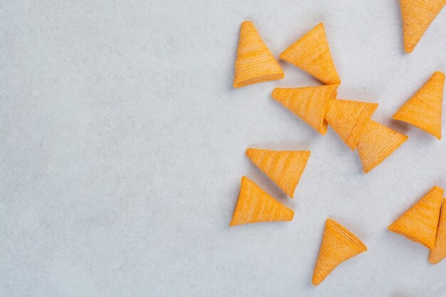 Tasty yellow crunchy chips on white background. High quality photo